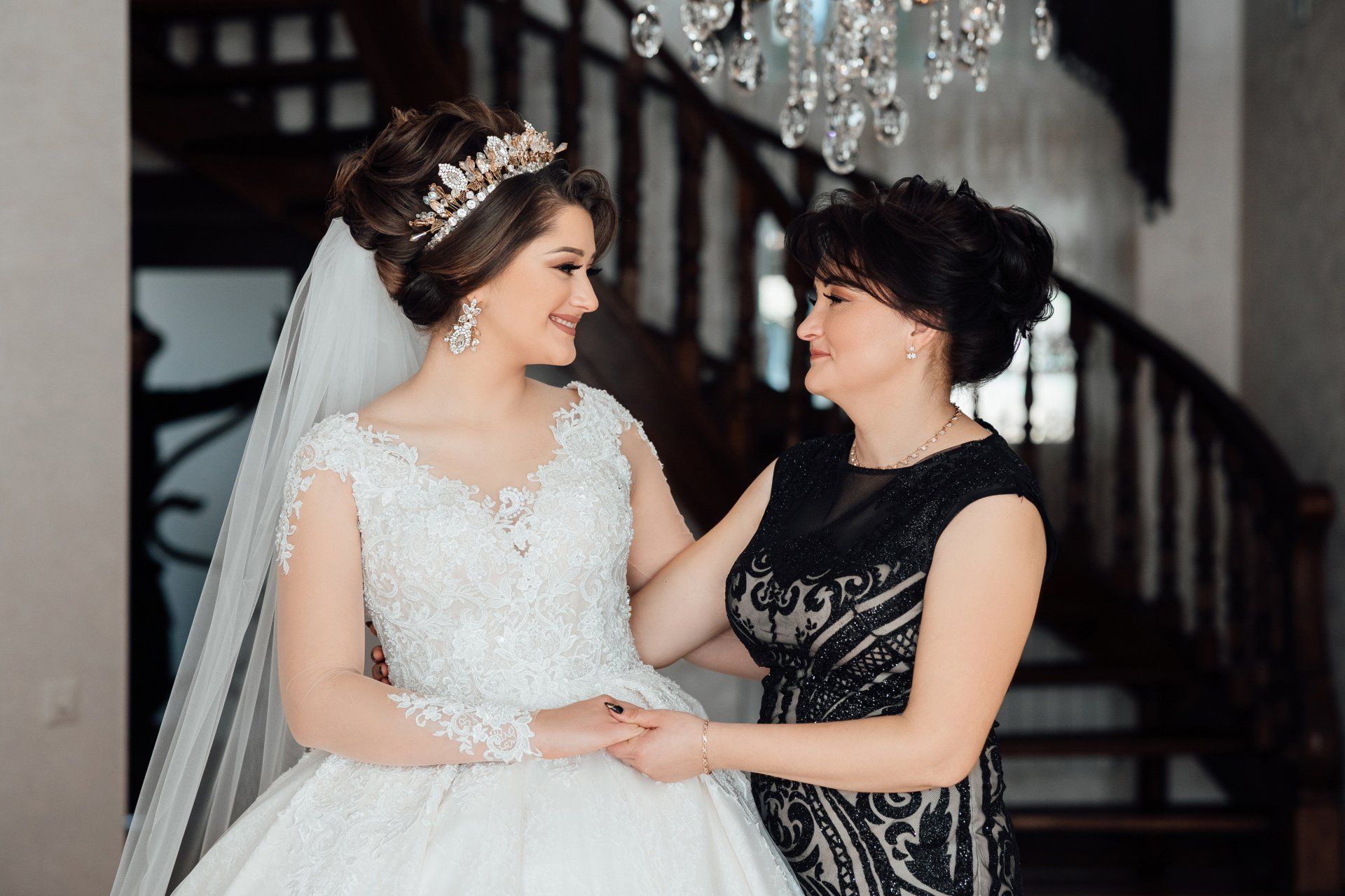 Happy mother holds bride's hand standing with her in the room in Washington, PA