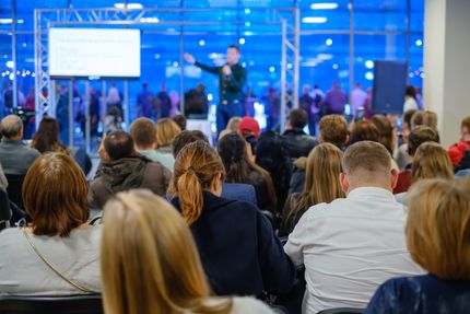 A man is giving a presentation to a large group of people.