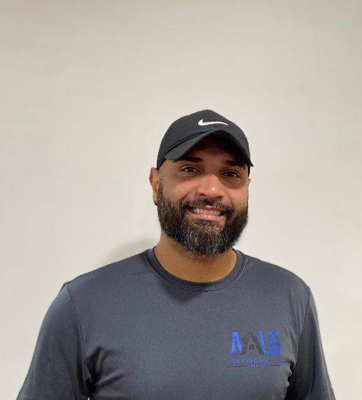 A man with a beard wearing a black nike hat