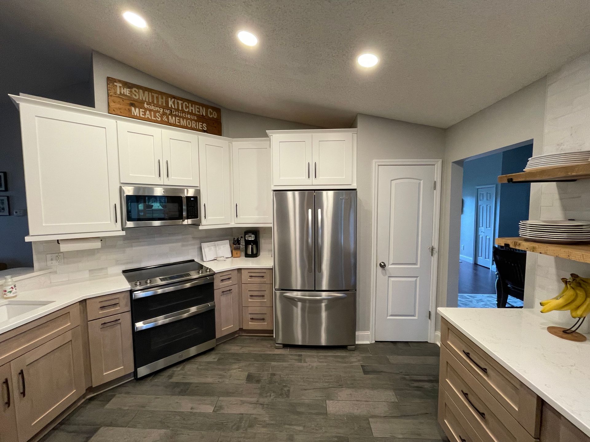 A kitchen with stainless steel appliances and white cabinets