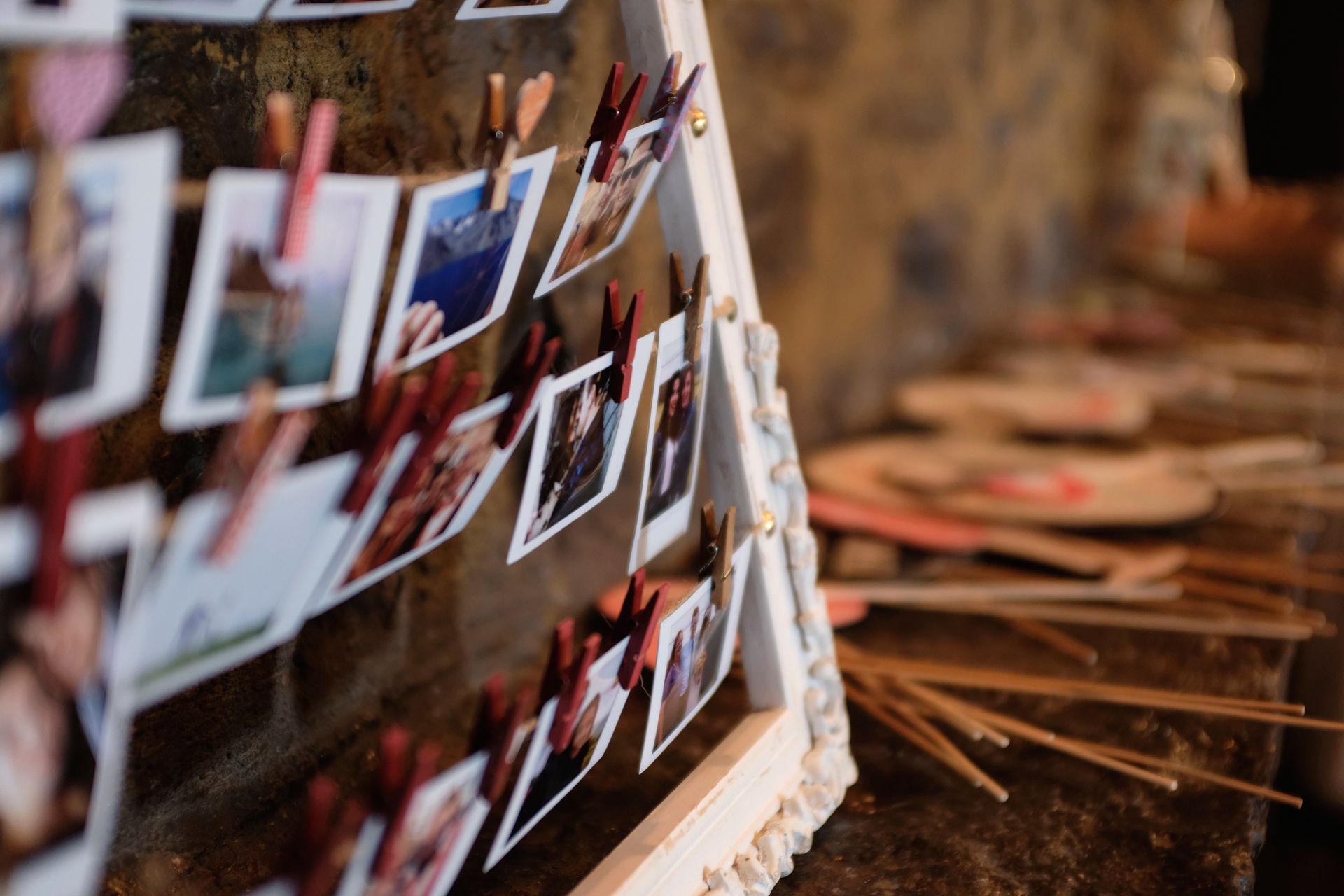 Photos clipped to strings on a white, angled display.