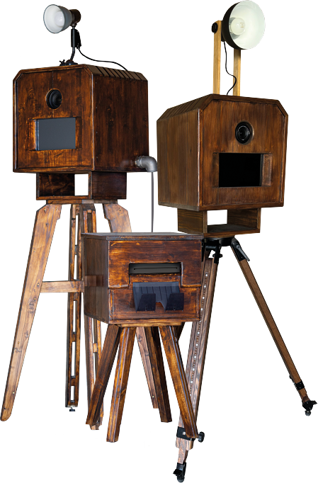 Zwei Vintage-Fotoautomaten aus Holz mit angebrachten Lichtern auf Stativen.