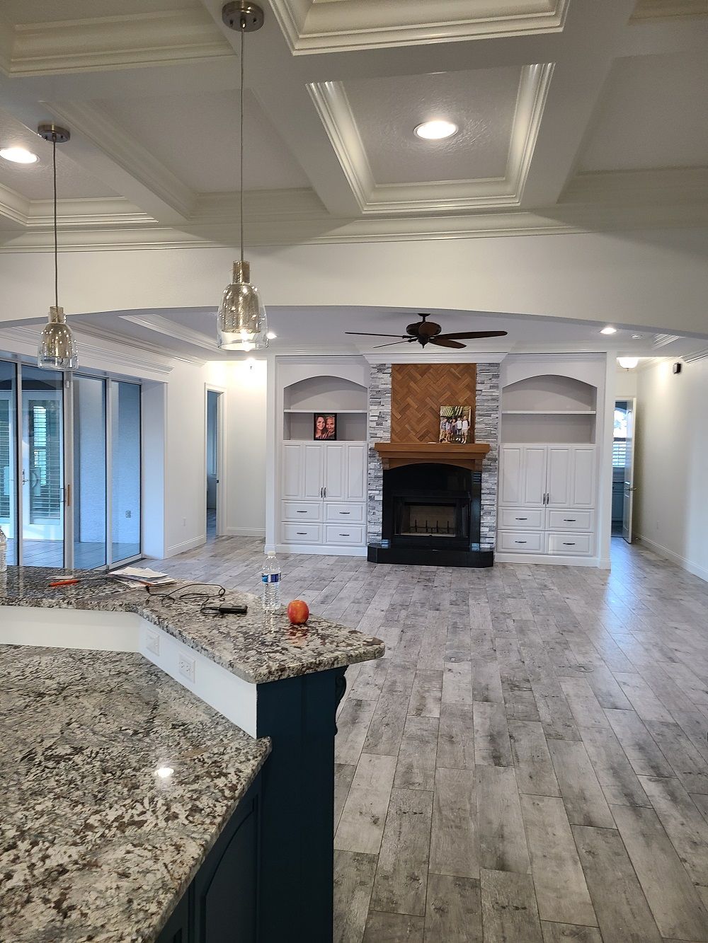 A kitchen with granite counter tops and a fireplace.