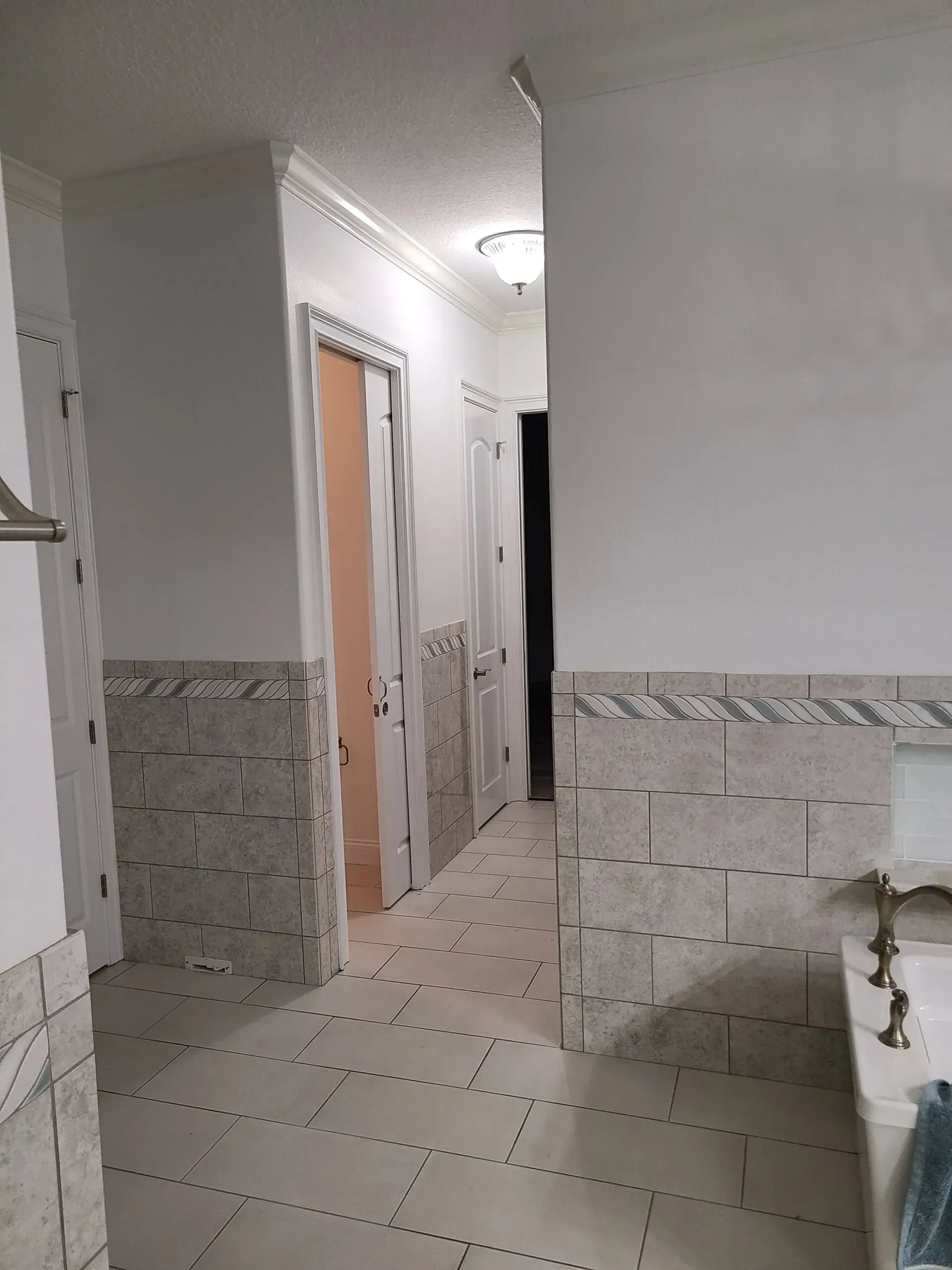 A bathroom with tile floors and a sink.
