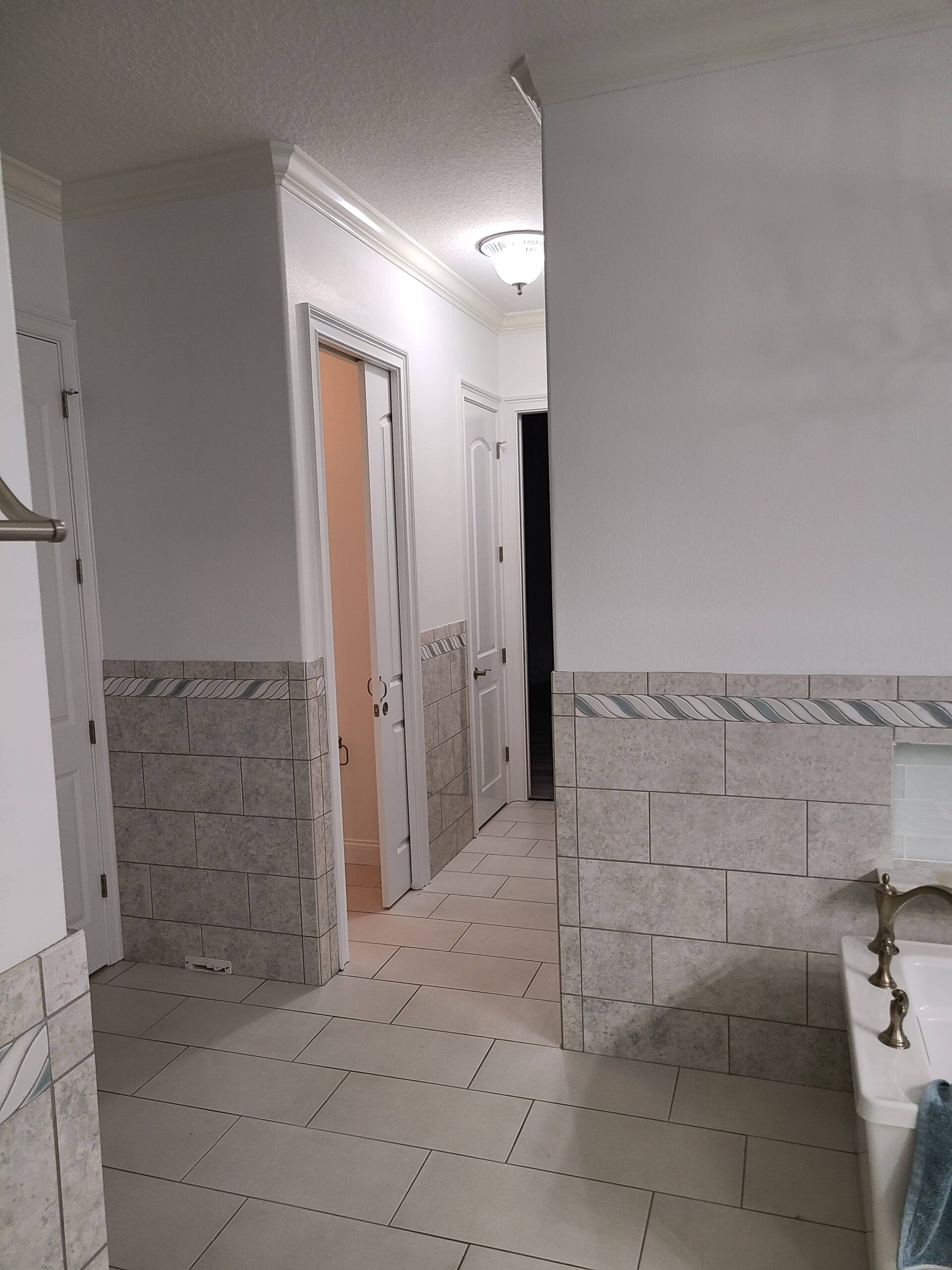 A bathroom with a sink , toilet , and door.