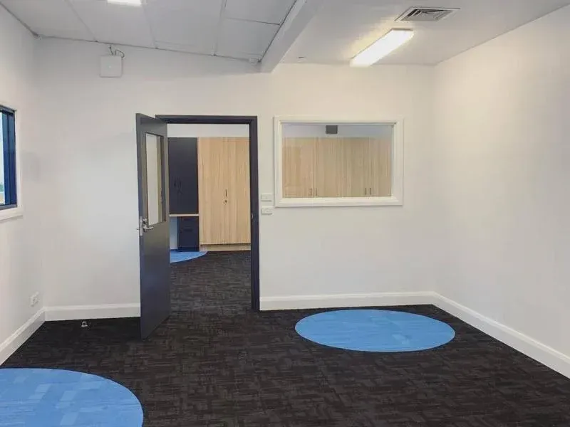 An empty room with blue circles on the floor