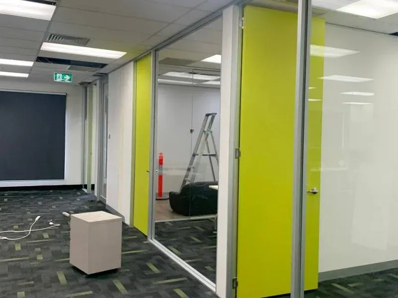 A room with yellow walls and a ladder in it