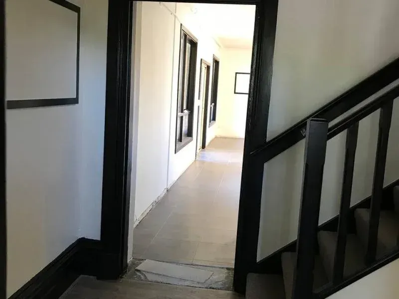 A hallway with stairs leading up to the second floor