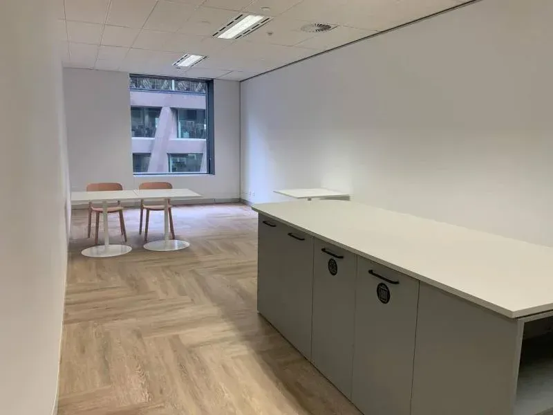 There is a table and chairs in the room.