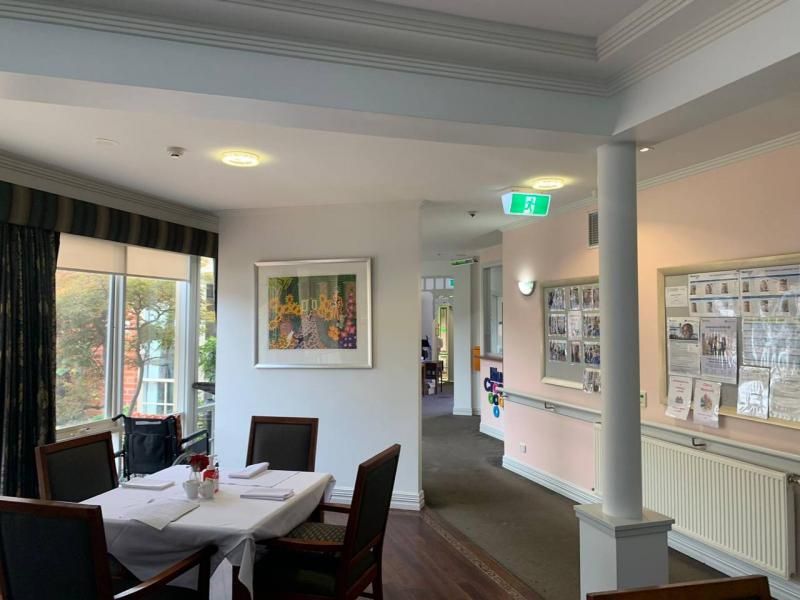 A dining room with a table and chairs in a nursing home.