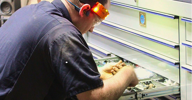 Car in a repair shop with a mechanic grinding metal, creating sparks | Don's Repair