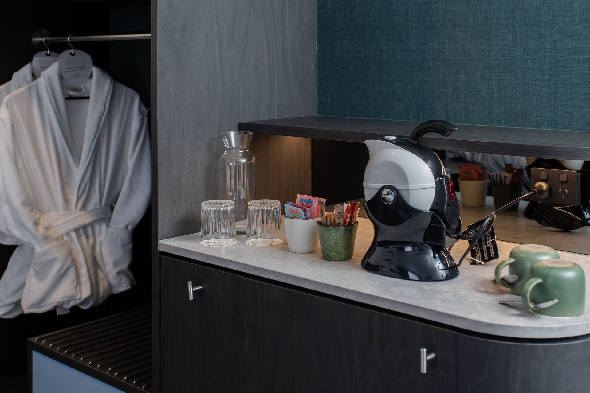 Hotel room: coffee station with kettle, cups, and supplies. Robe in the closet.