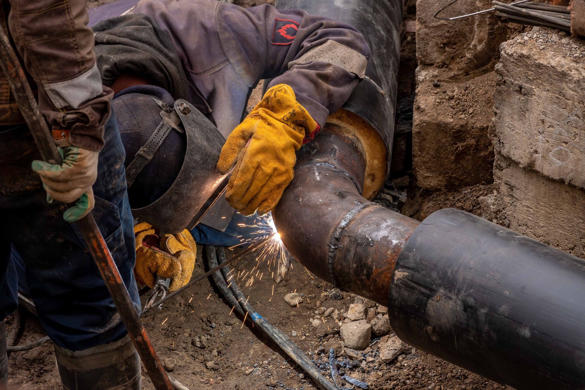Buried pipeline in a dirt trench with gravel lining the pipe