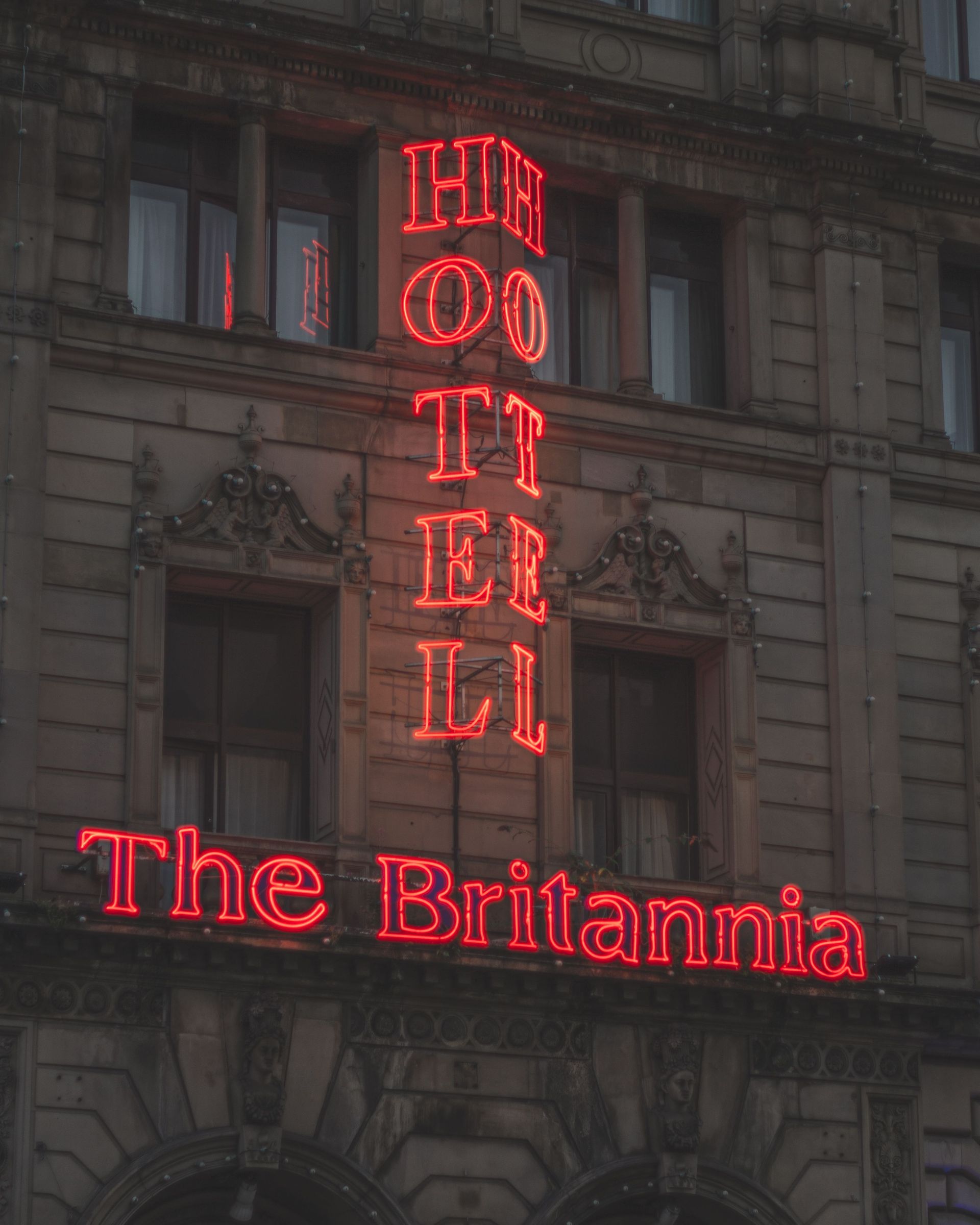 Red neon hotel sign reading 