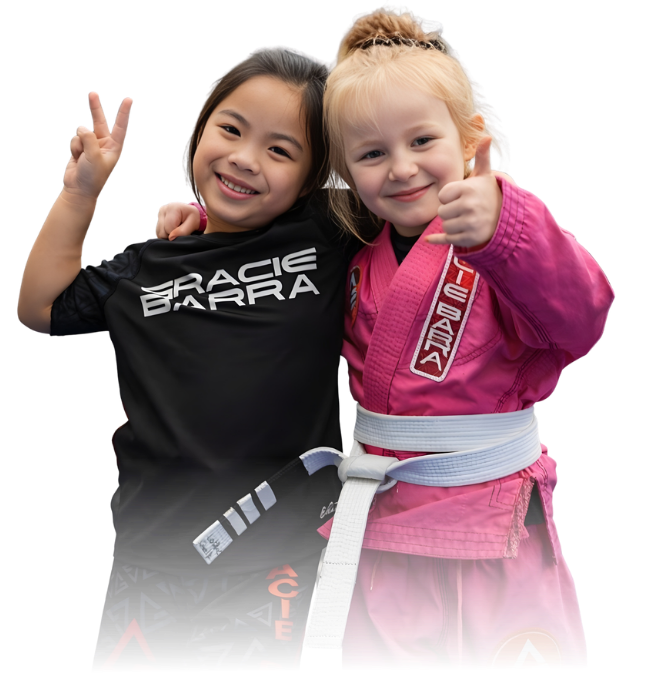 Man pointing, smiling, wearing black hoodie; arm tattoo visible.