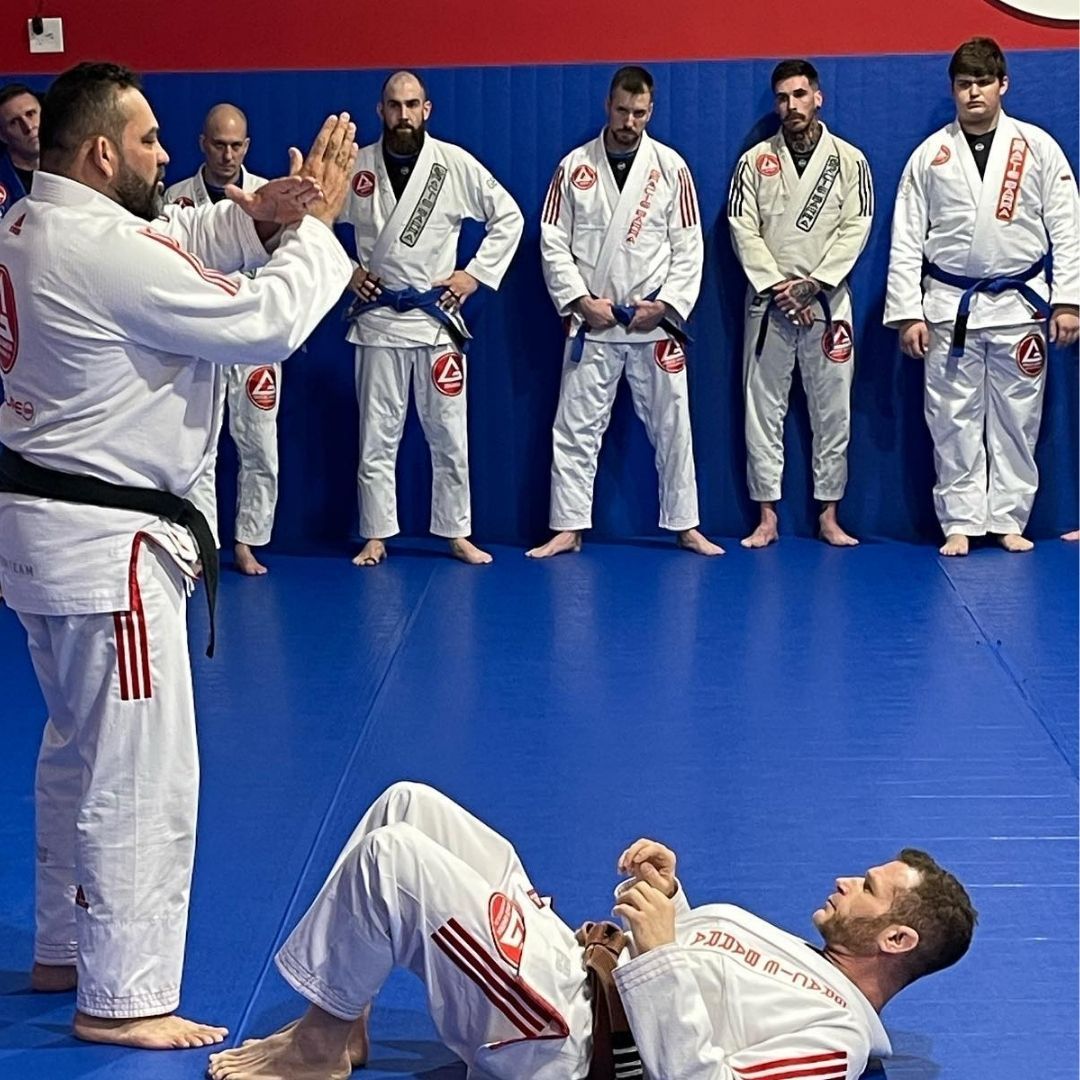 Four men in athletic gear, posing for a photo in a gym.