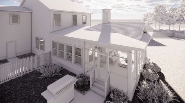 An aerial view of a white house with a porch.