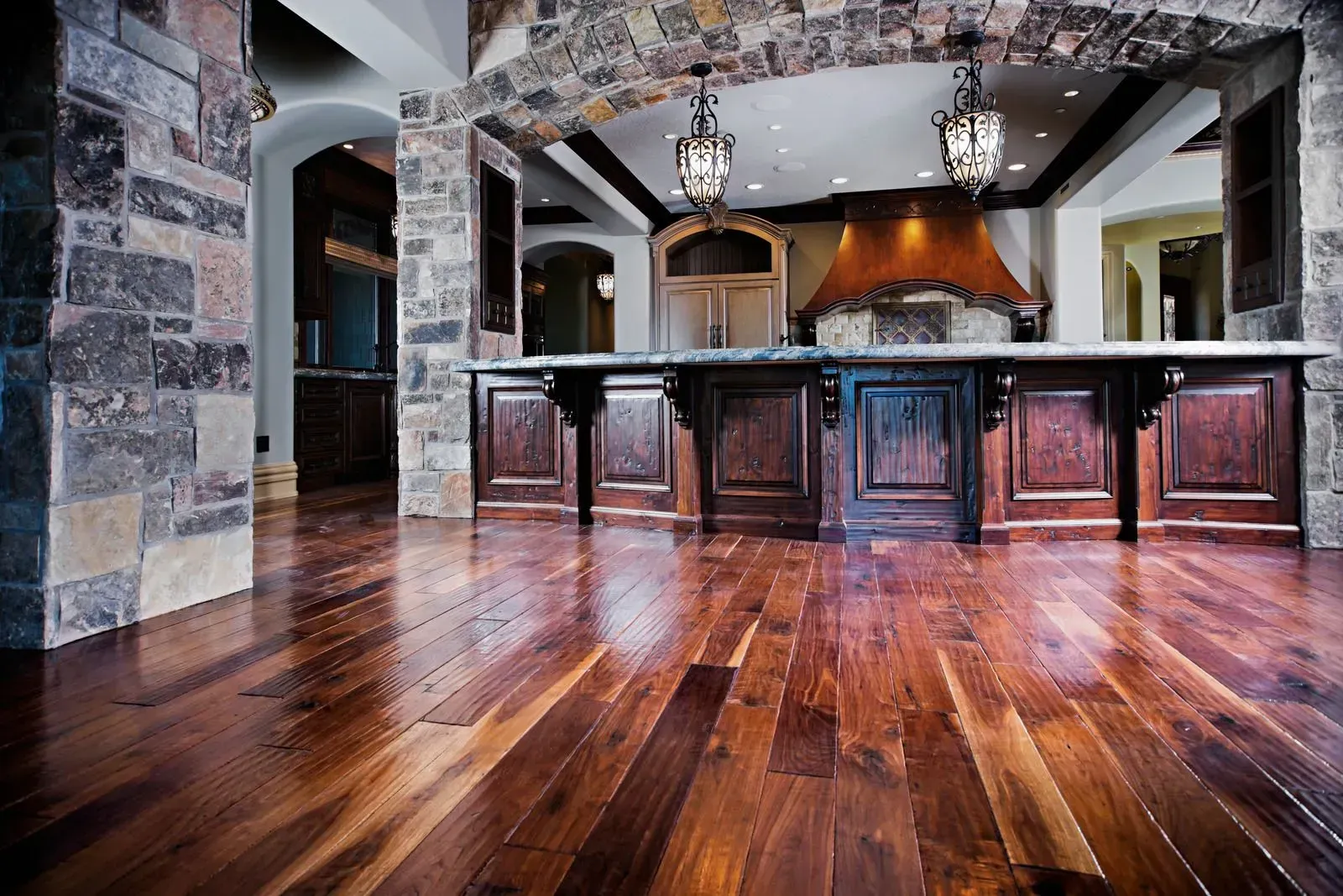 A kitchen with hardwood floors and a large island