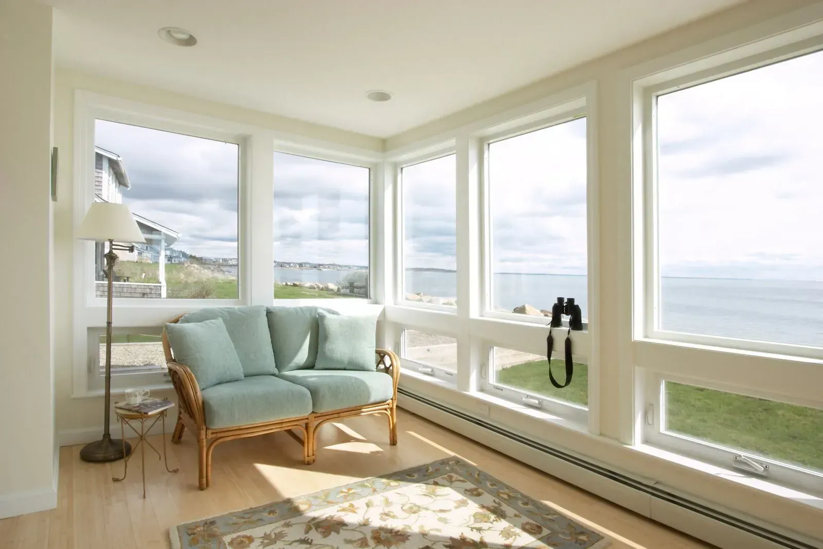 A living room with a couch and a view of the ocean