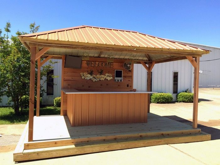 Wooden outdoor bar under a metal-roofed gazebo,