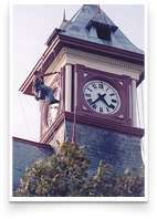The front clock face on this tower in Winchester, VA, has a fresh coat of paint. Notice the hand prepared clock face below the man painting. Paint and primer carefully applied by hand reduces 