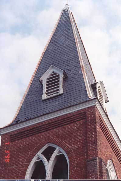 Steeple with loose shingles before repairs
