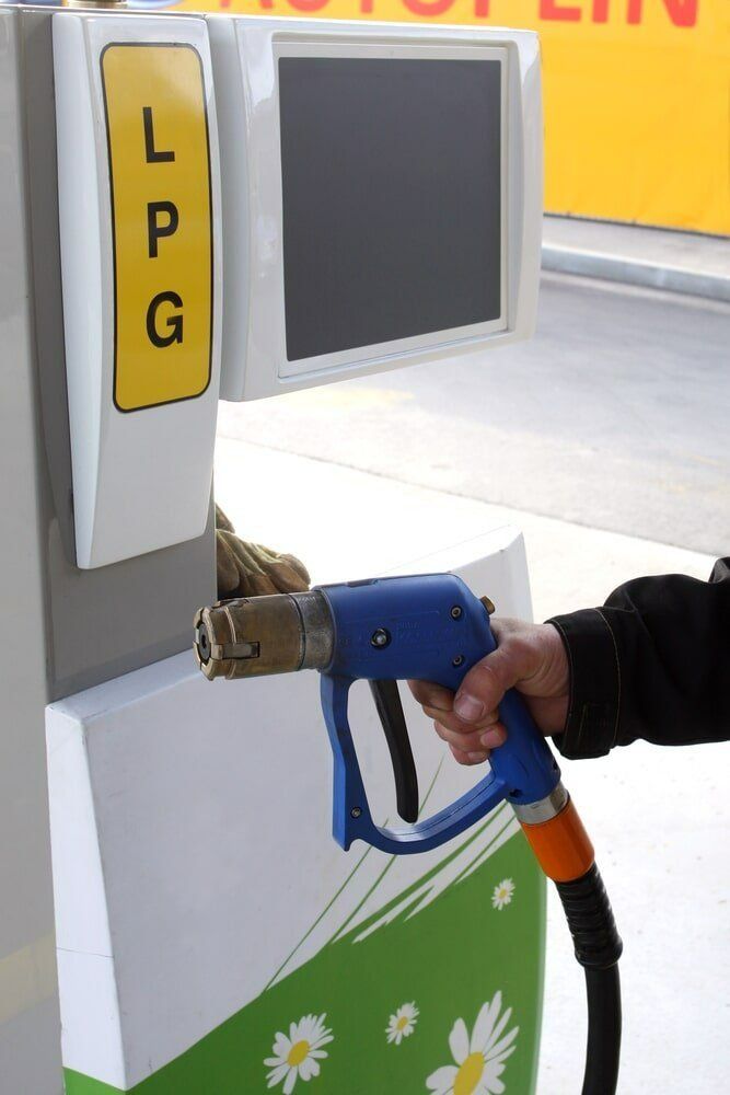 Person Filling Up a Car With Lpg Fuel — Warners Bay Tyre & Mechanical in Warners Bay, NSW