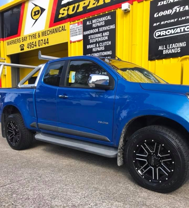 Blue Pickup Truck Parked Outside a Yellow Auto Shop — Warners Bay Tyre & Mechanical in Warners Bay, NSW