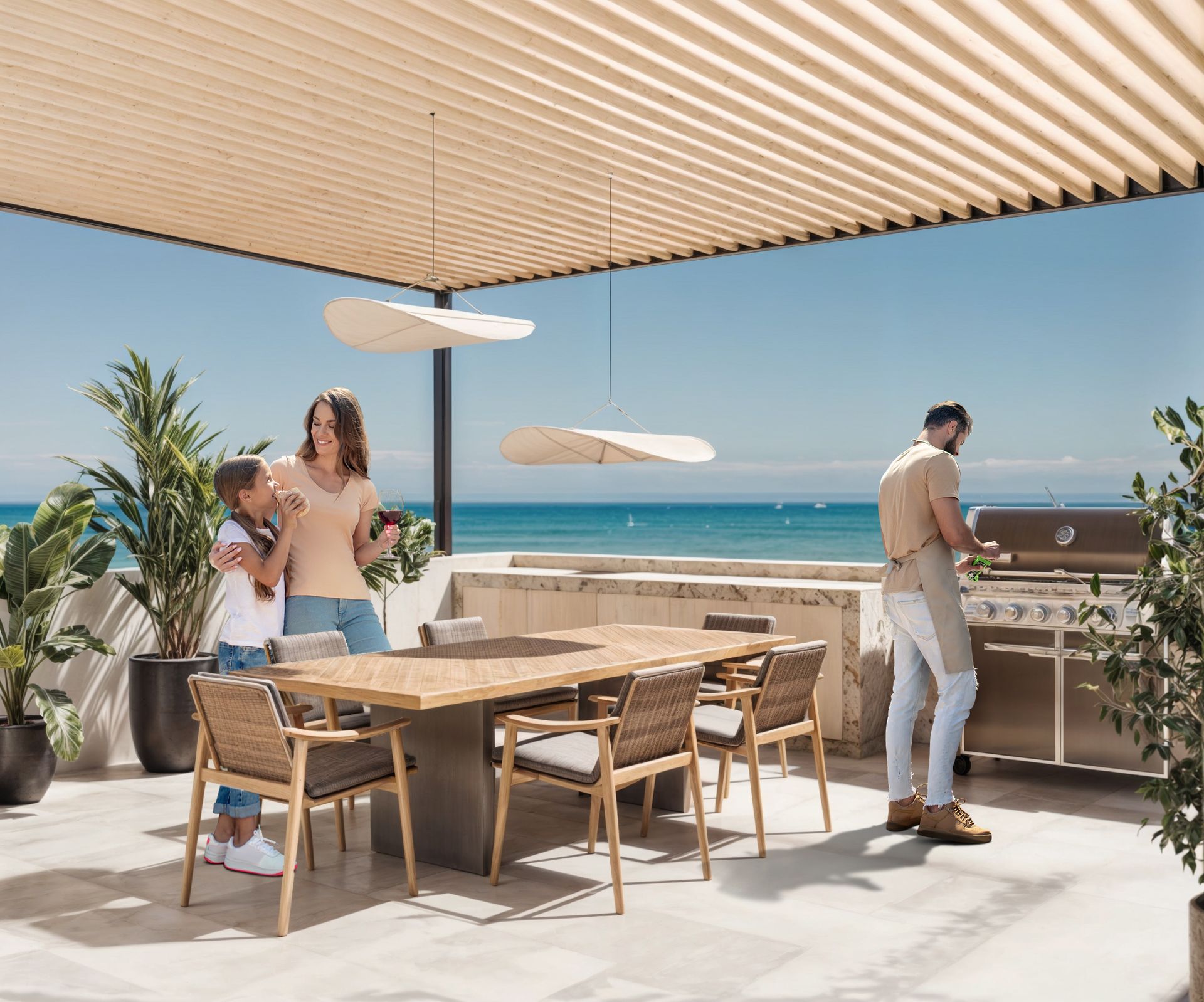 Familia asando al aire libre junto al mar. Un hombre en la parrilla, una mujer y un niño en la mesa   para casas en Tijuana