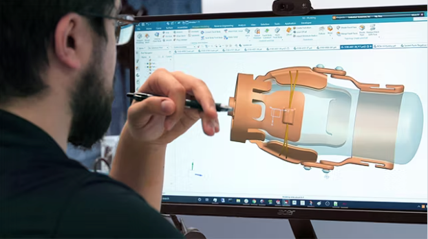 Man with beard using a stylus on a computer screen, designing a 3D model of a mechanical component.