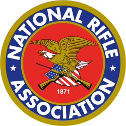 NRA logo: gold eagle, rifles, American flag, red/blue circle, blue text 