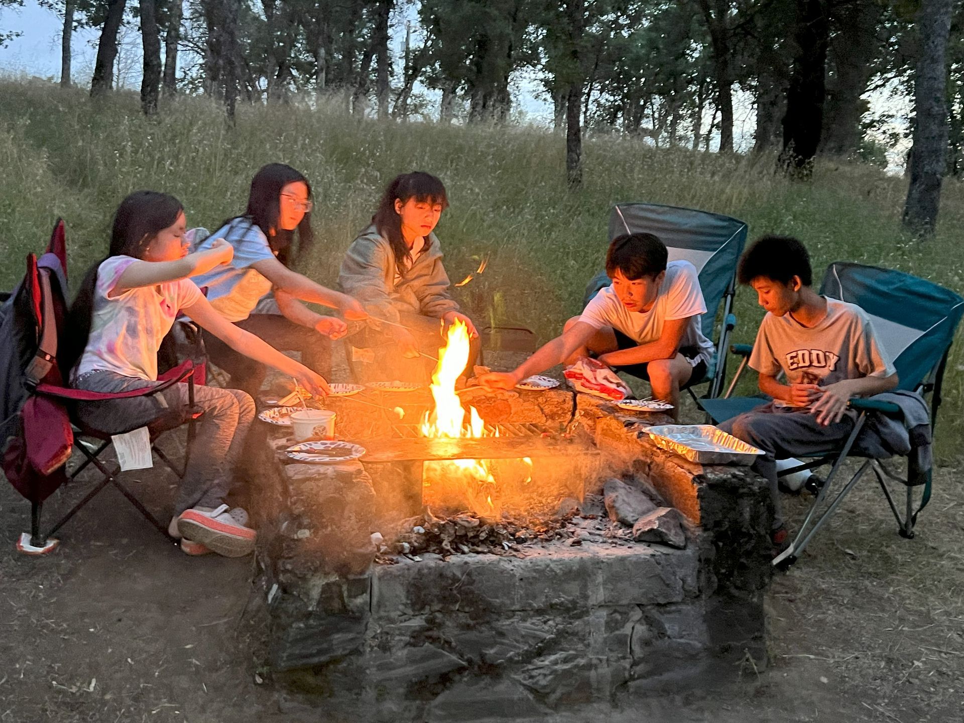 Young people around campfire