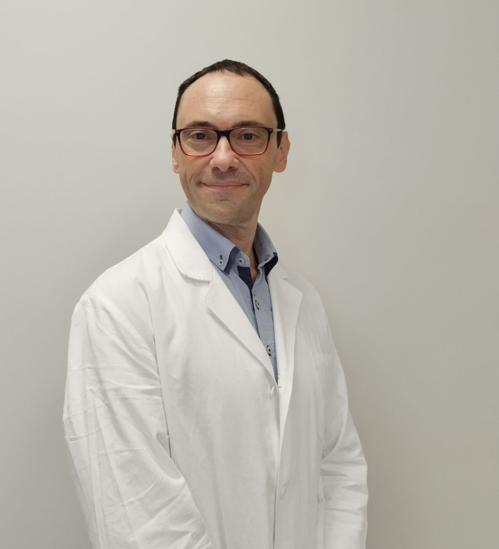 Un uomo con gli occhiali e un camice bianco