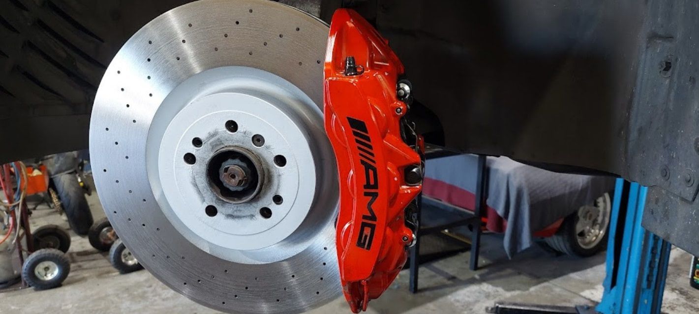 A Close Up Of A Brake Disc And Brake Caliper On A Car — Albion Park Auto Electrical & Mechanical In  Albion Park Rail, NSW