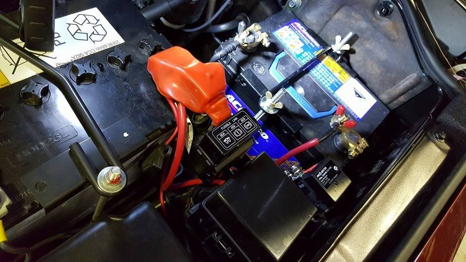 A Close Up Of A Car Battery With Red Wires Coming Out Of It β Albion Park Auto Electrical & Mechanical In Albion Park Rail, NSW