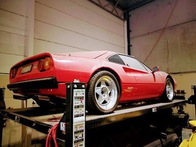 A Red Sports Car Is Parked On Top Of A Trailer In A Garage β Albion Park Auto Electrical & Mechanical In Albion Park Rail, NSW