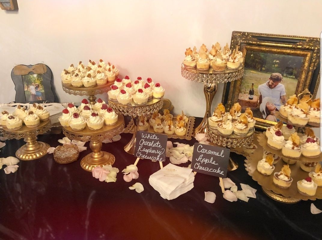 A table topped with cupcakes and a picture of a man.