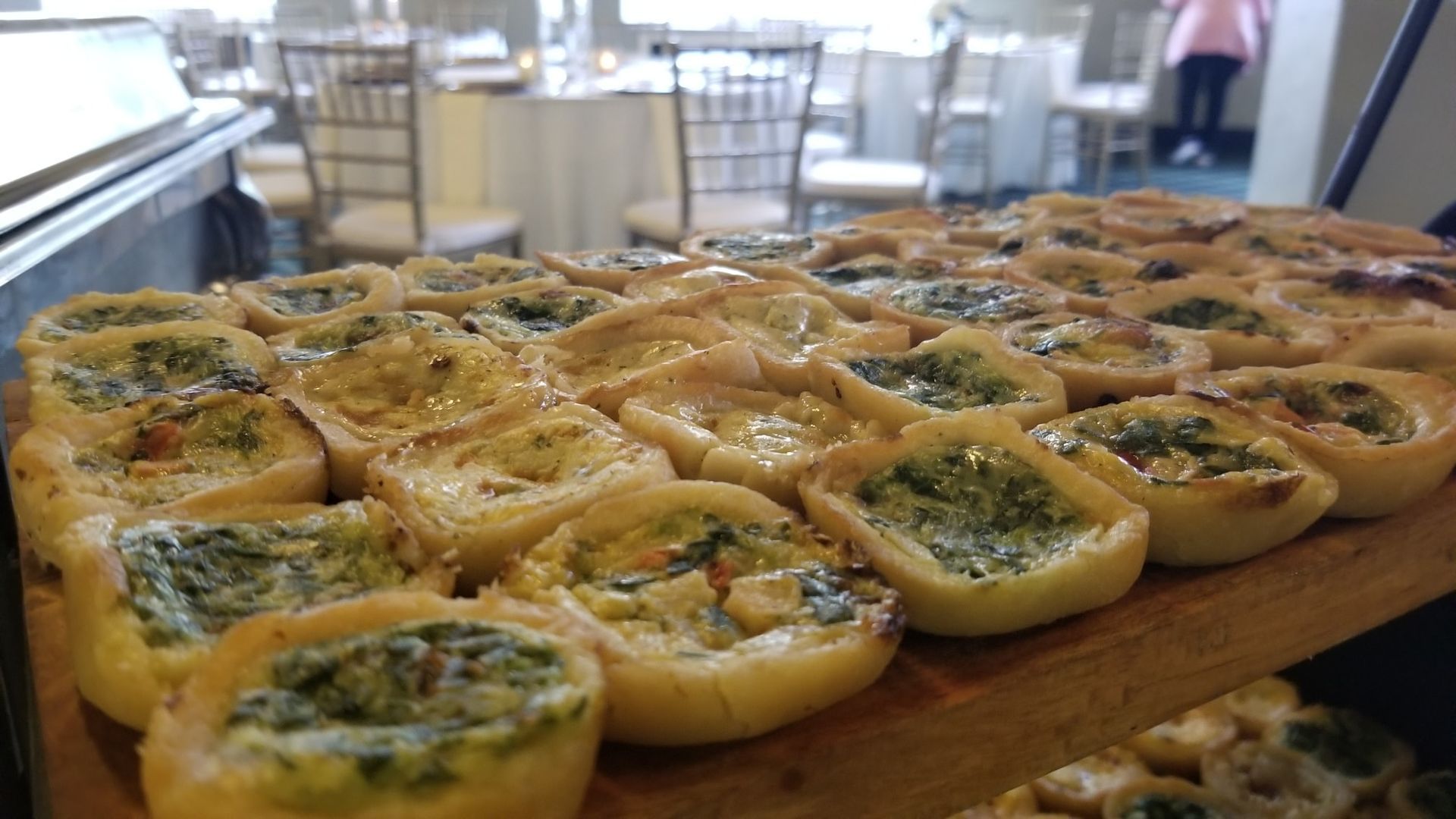 A wooden cutting board topped with a variety of pastries.