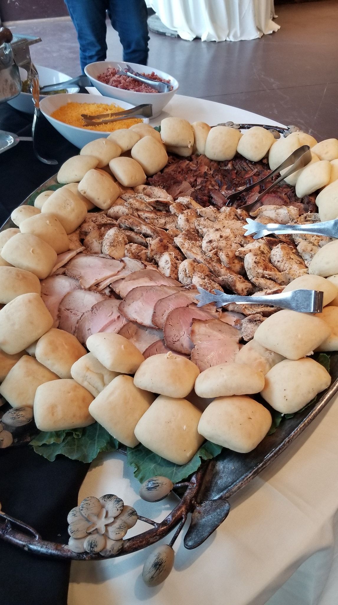 A buffet table with a variety of food and biscuits on it.
