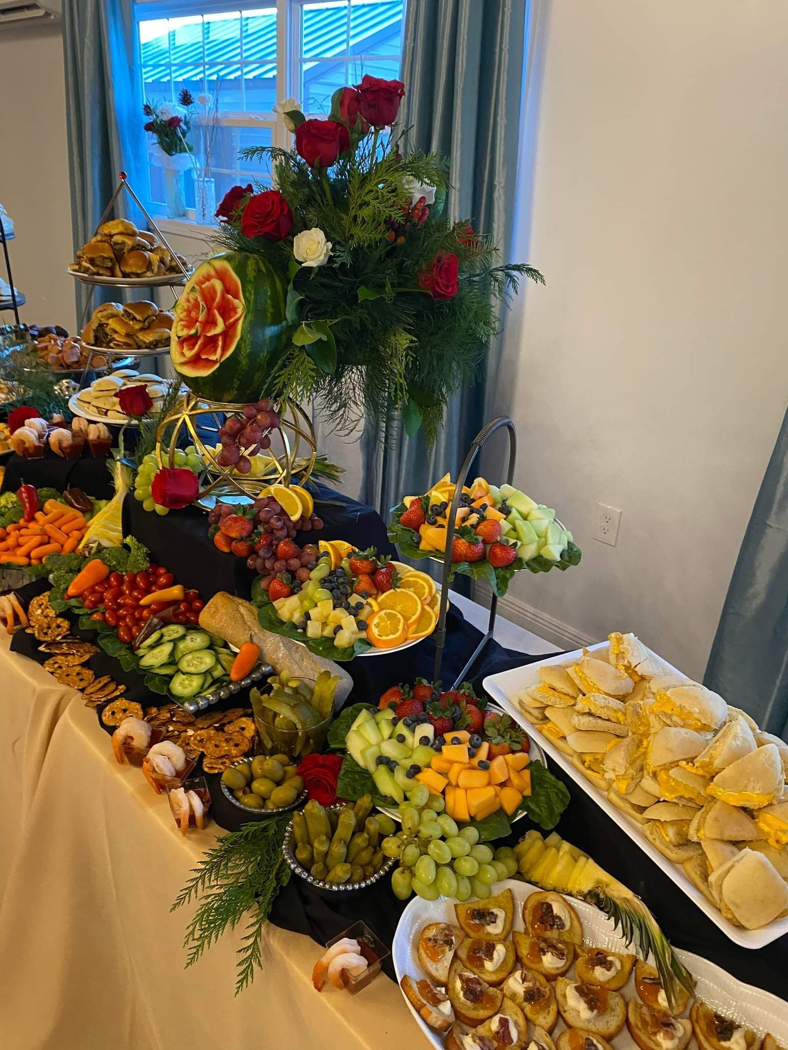 A buffet table filled with lots of fruits and vegetables.