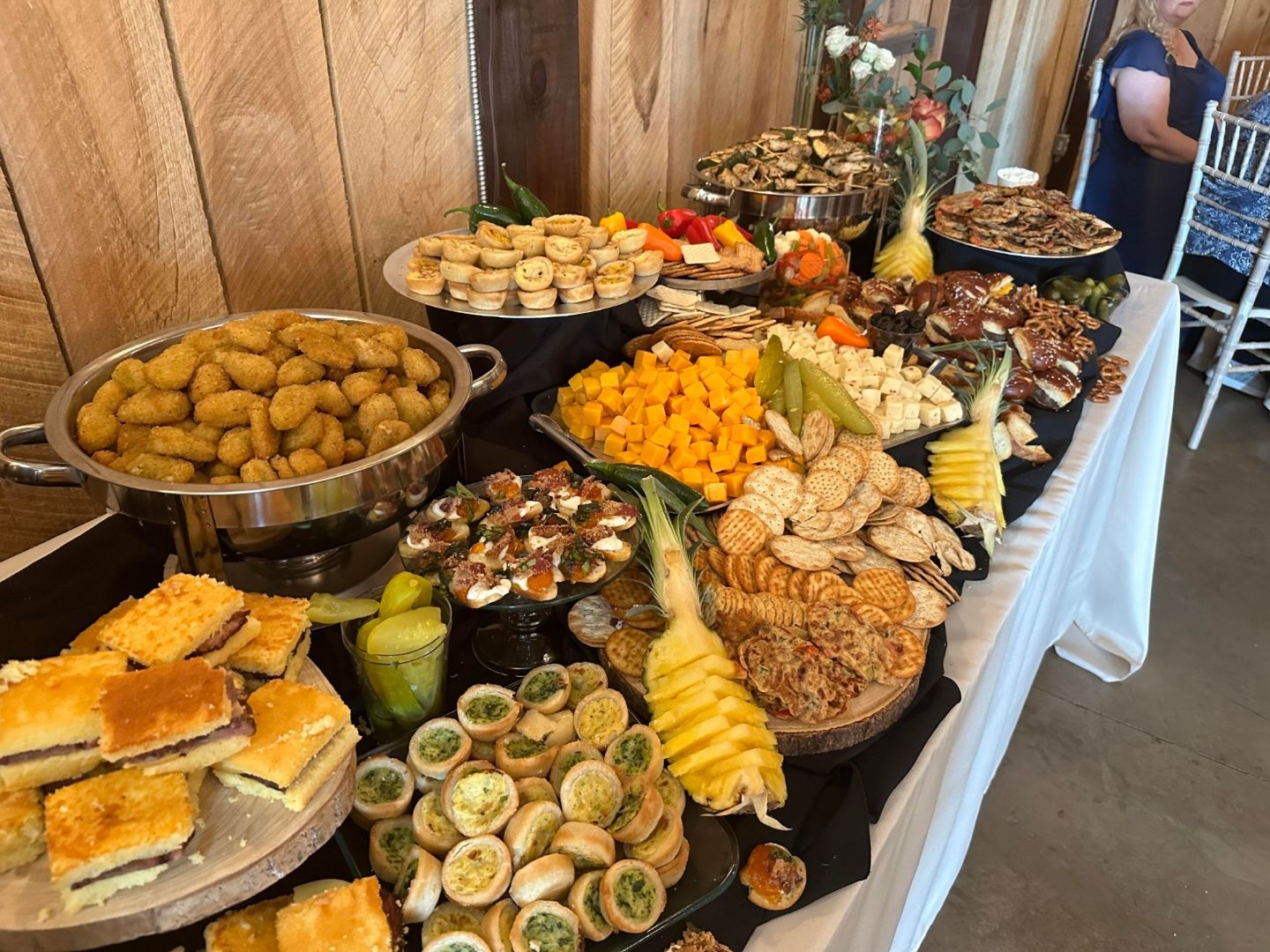 A buffet table with a variety of food on it.