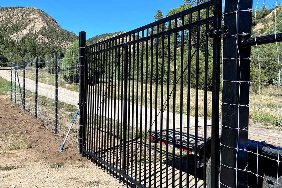 A black metal fence with barbed wire