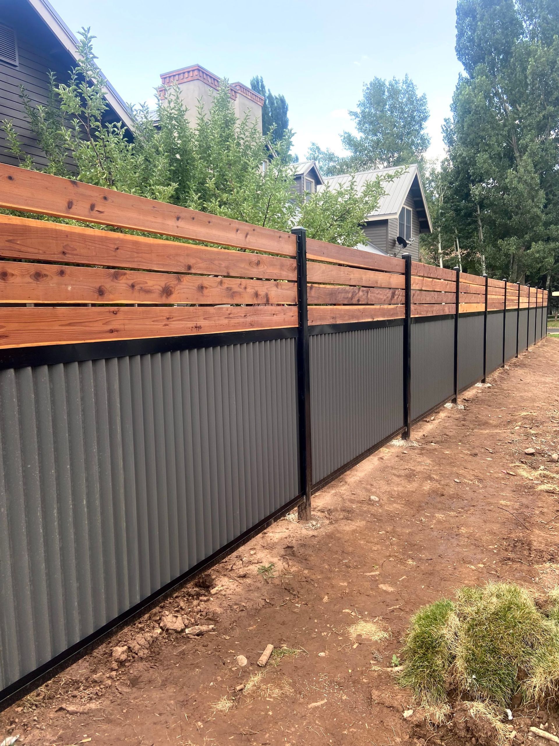 A fence made of corrugated metal and wood