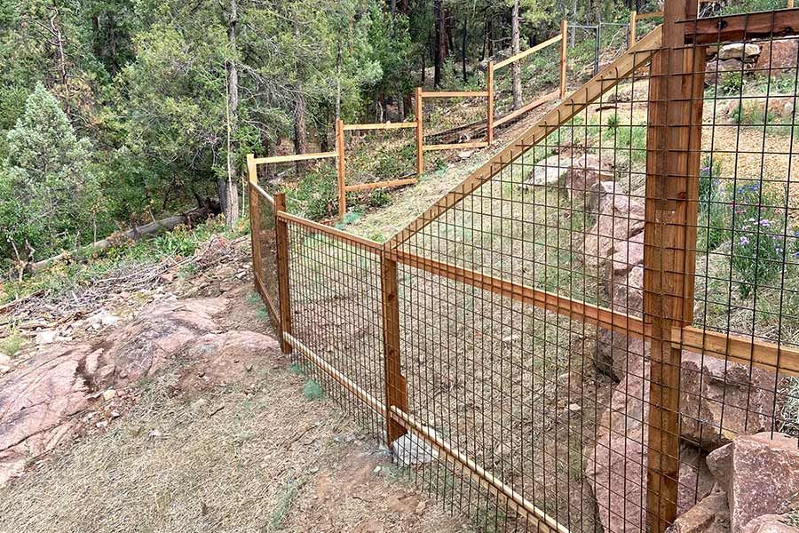 A wooden and wire fence