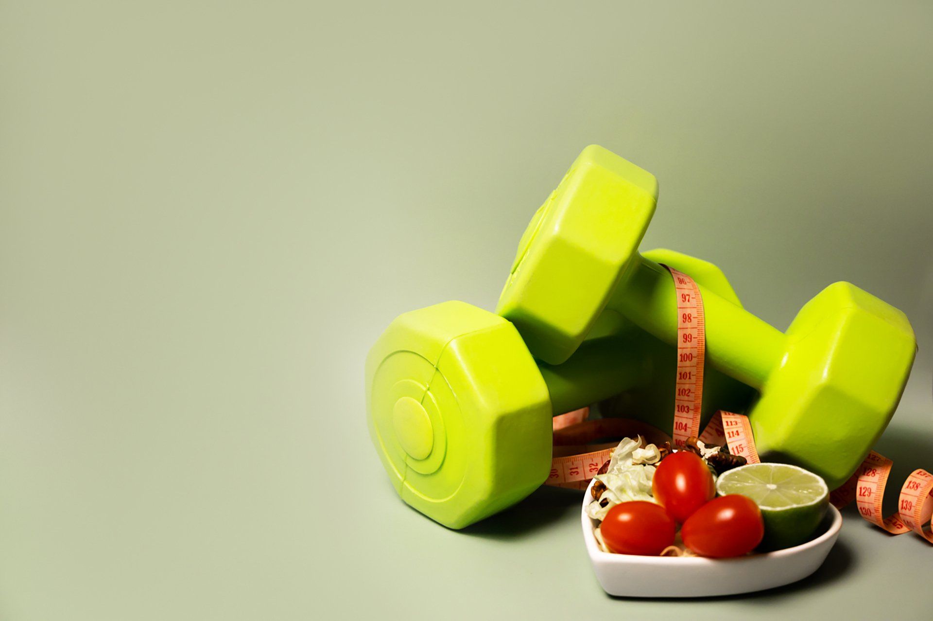 Healthy lifestyle and food concept.Sporty lifestyle. Workouts. Vegetables, fruits are near dumbbells.