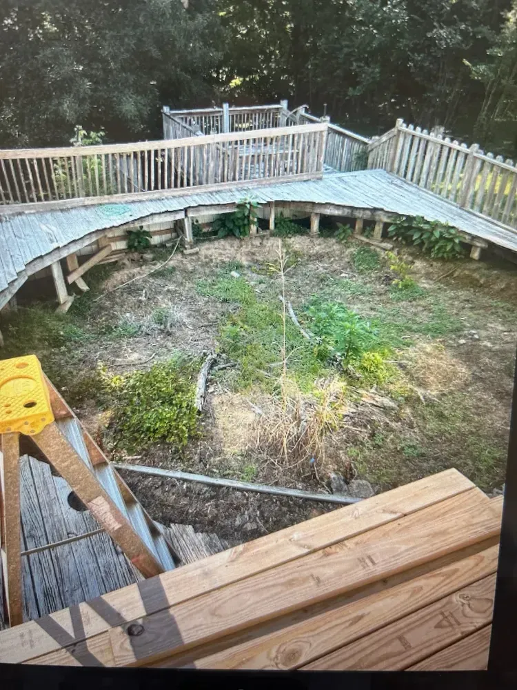 A wooden bridge is being built in the middle of a field.