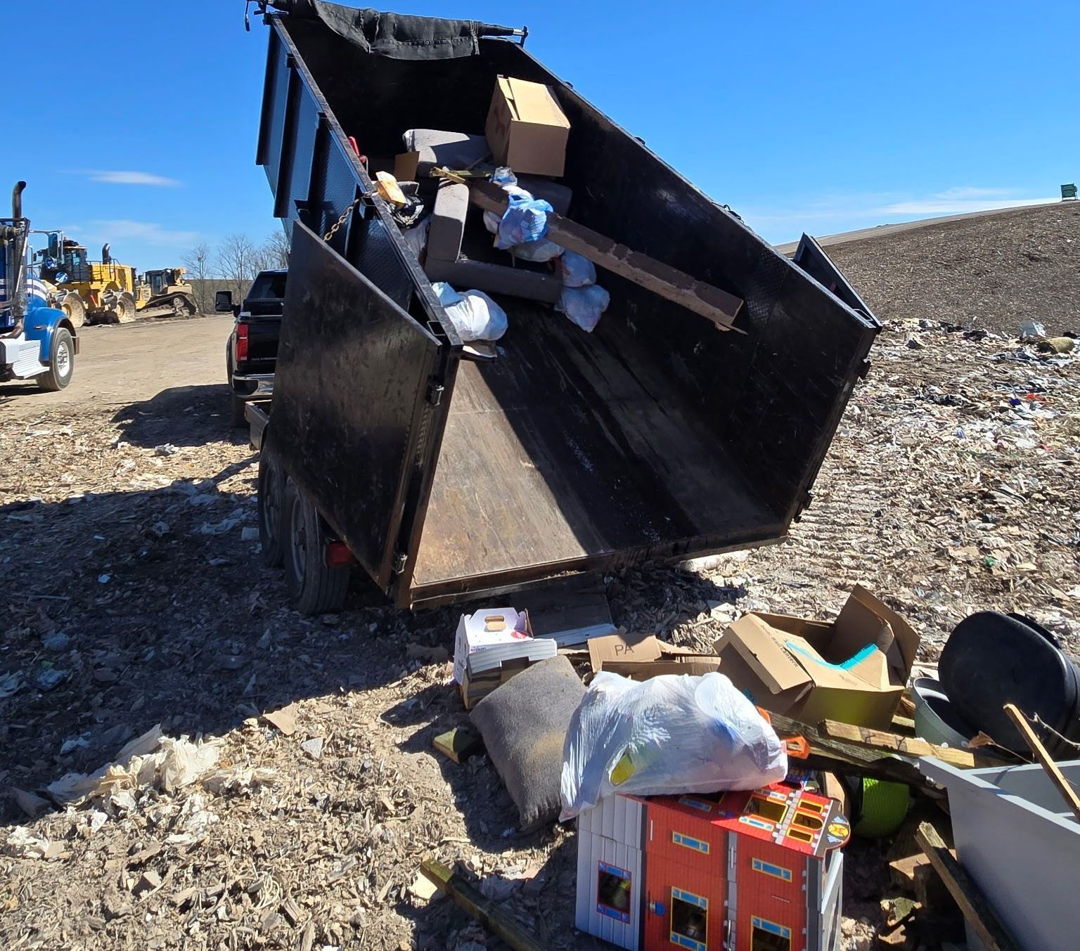 dump trailer unloading trash at landfill