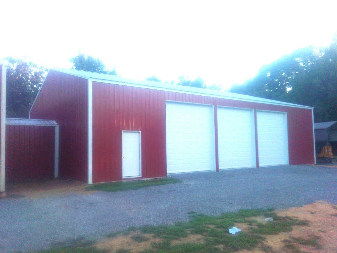 A large red barn with white garage doors