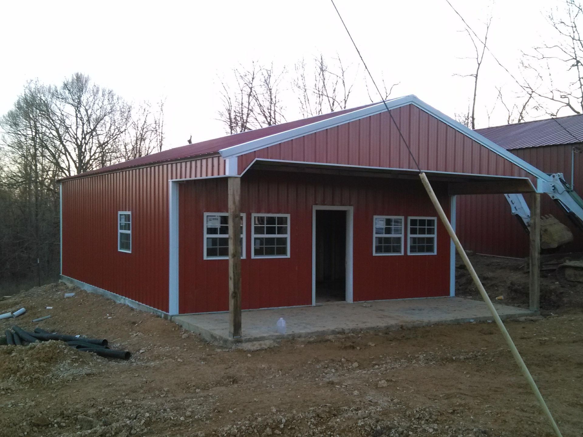 A red building with a white trim and a porch