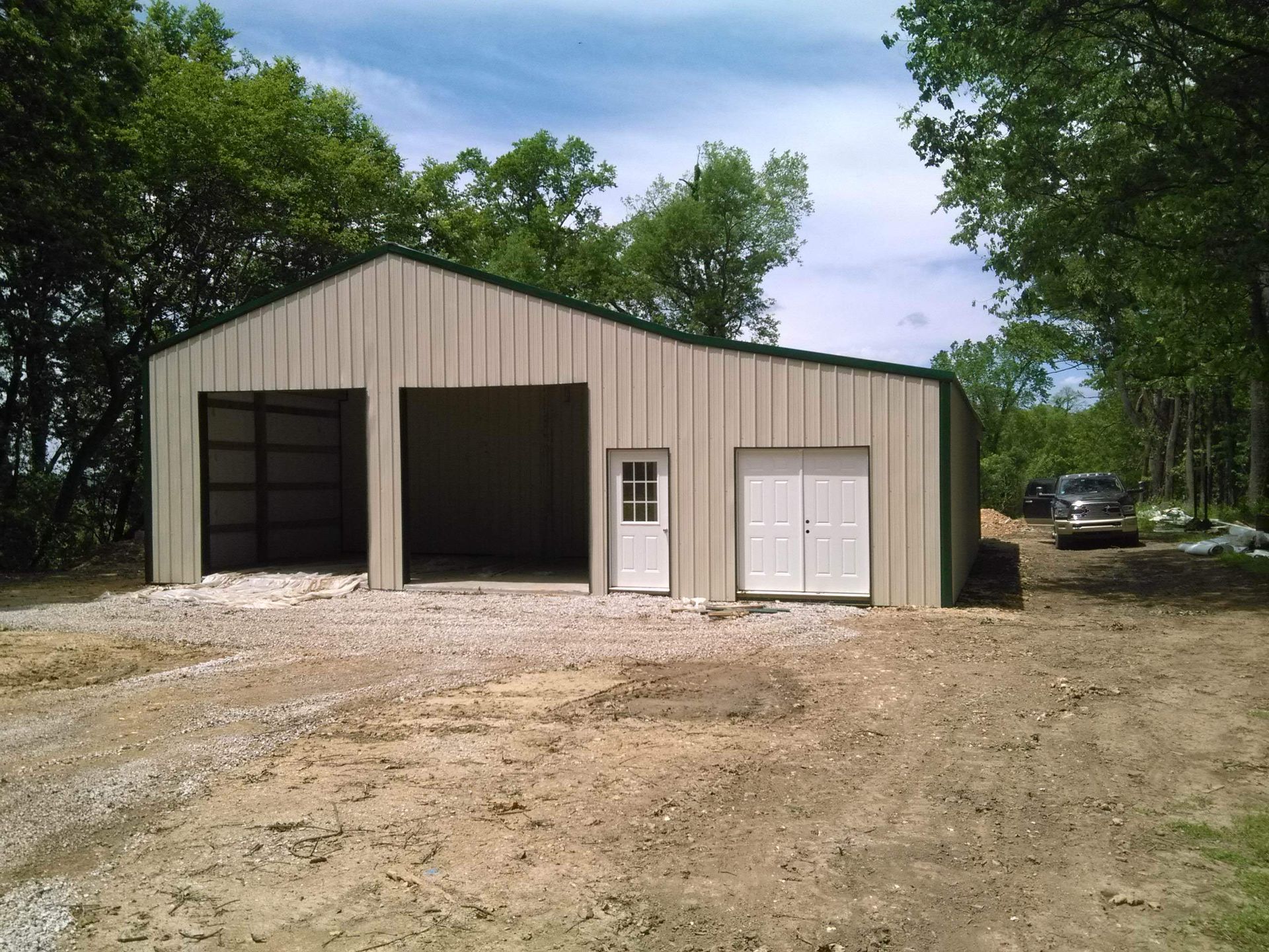 A garage with a green roof and a white door